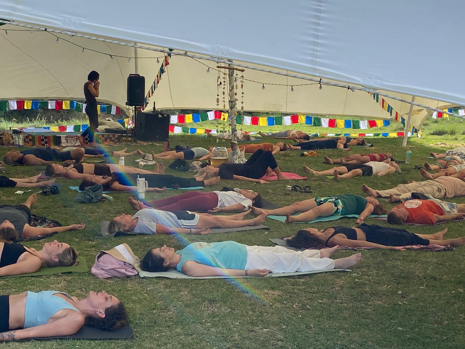 Deep relaxation in Savasana under the festival tent